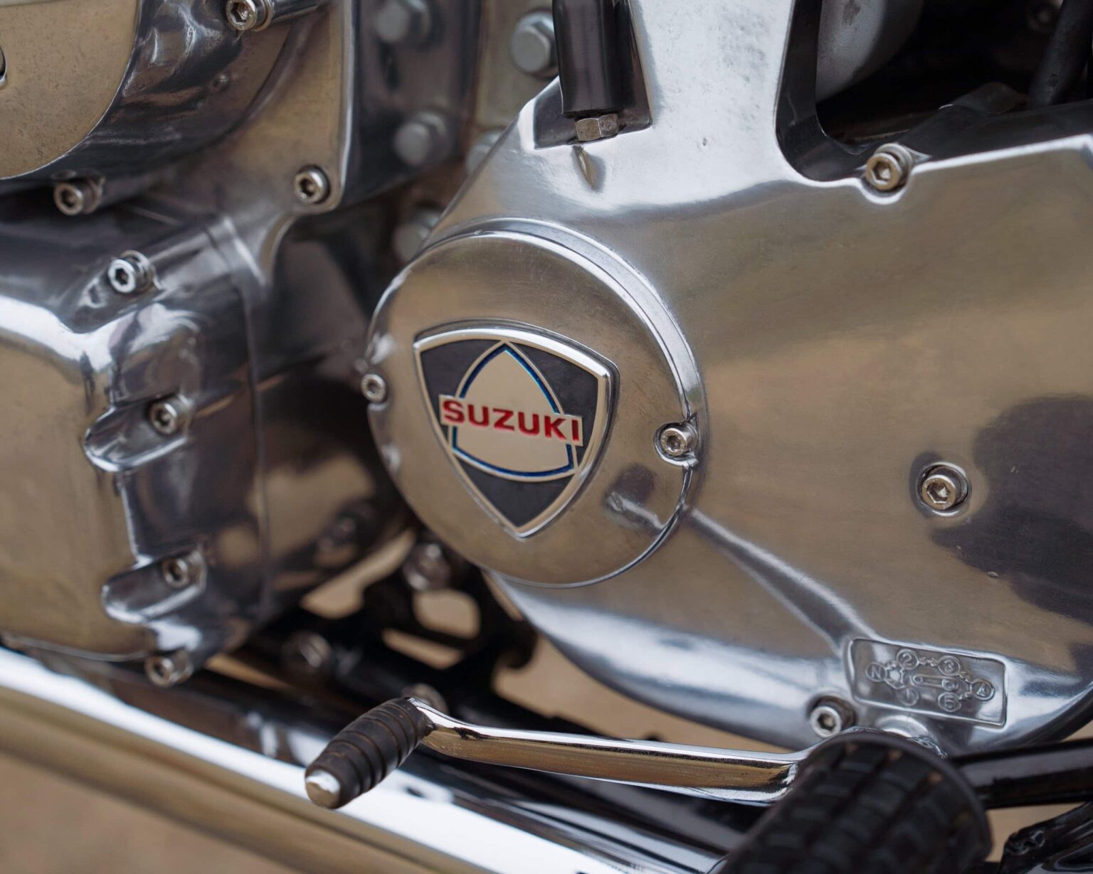 Close-up of a Suzuki motorcycle engine showcasing polished metal parts.