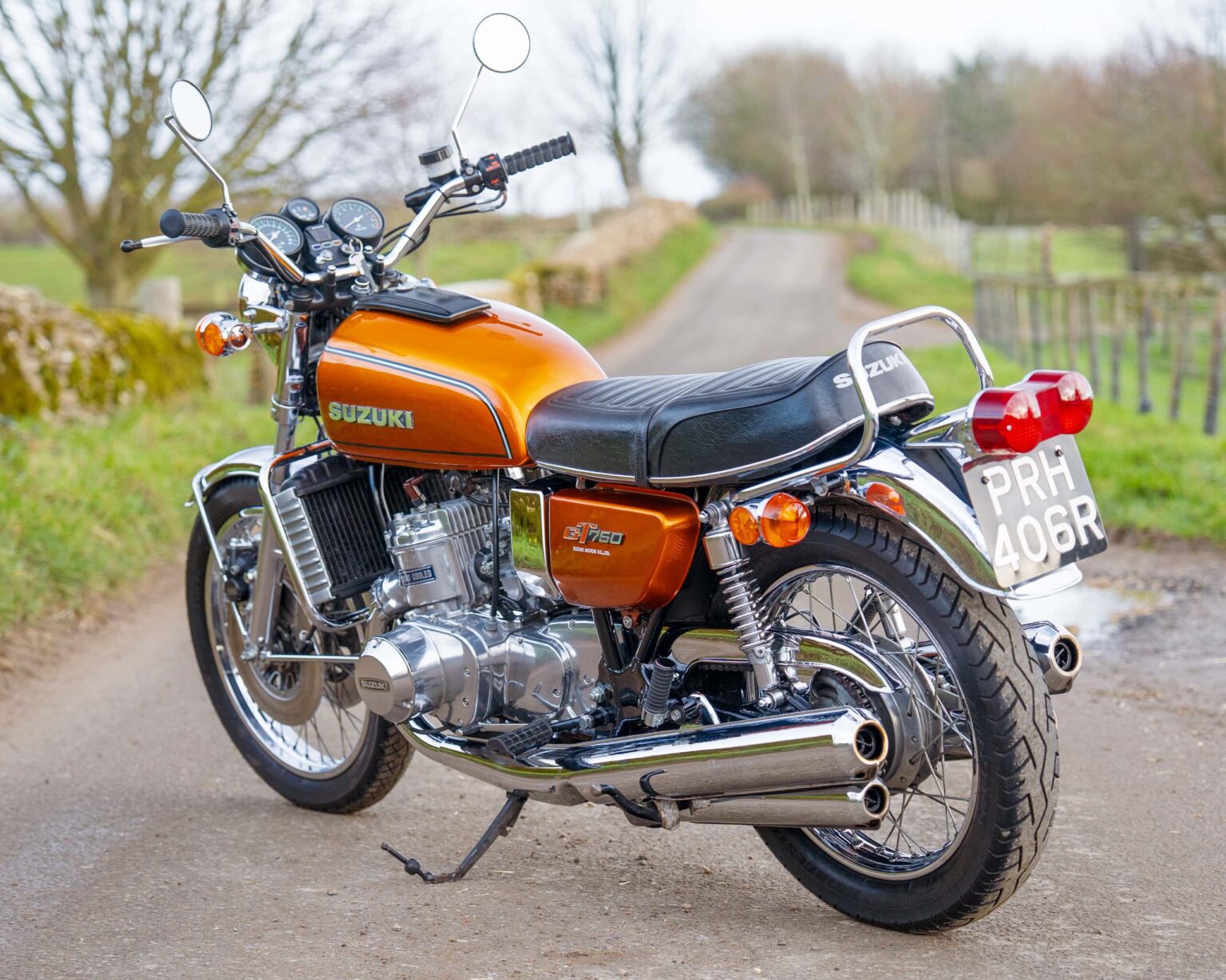 Suzuki vintage motorcycle on country road.