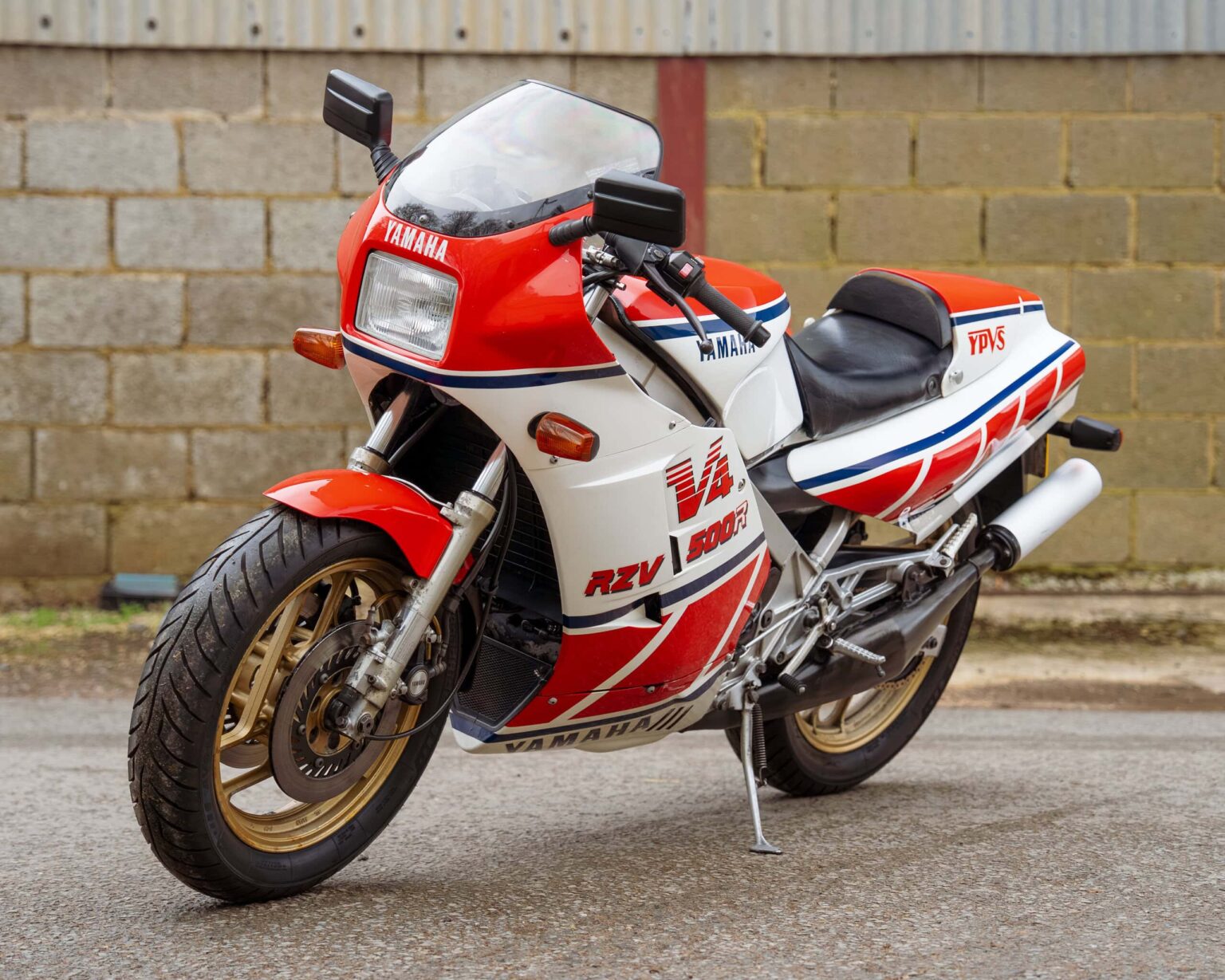 Yamaha TZR250 racing motorcycle with red, white, and blue livery.