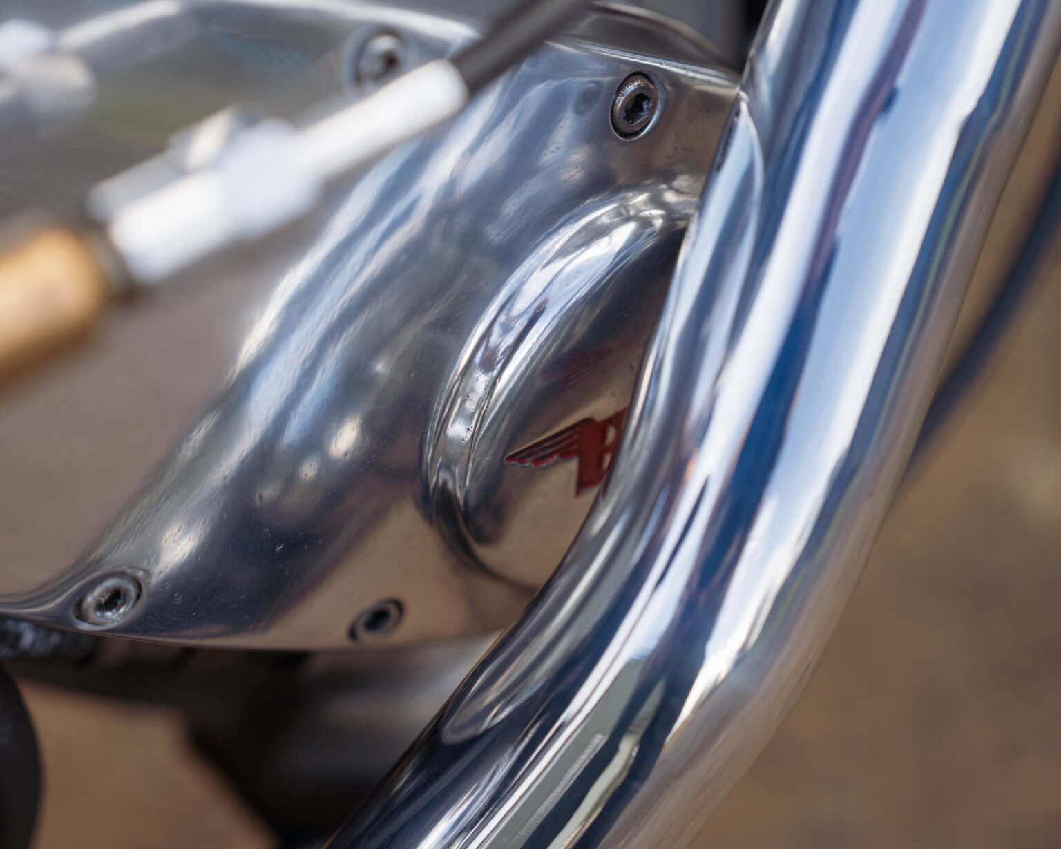 Up of a motorcycle engine showcasing polished chrome parts and detailed craftsmanship.
