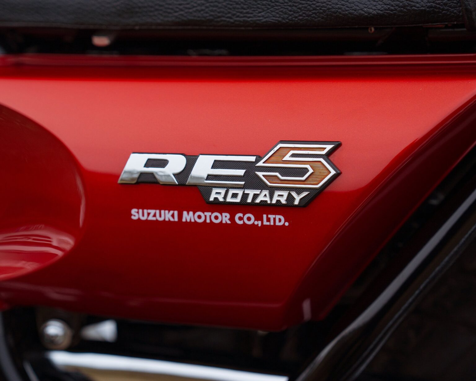 RE5 Rotary badge on a red Suzuki motorcycle side panel.