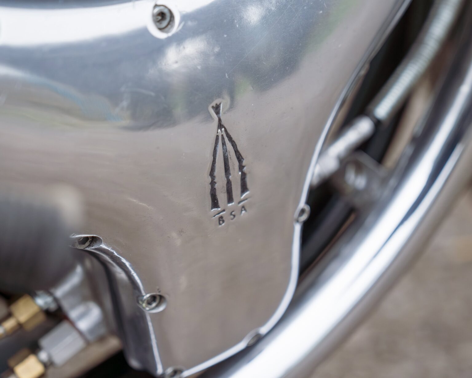 Close-up of vintage motorcycle engine cover with Classic Competition Company logo.