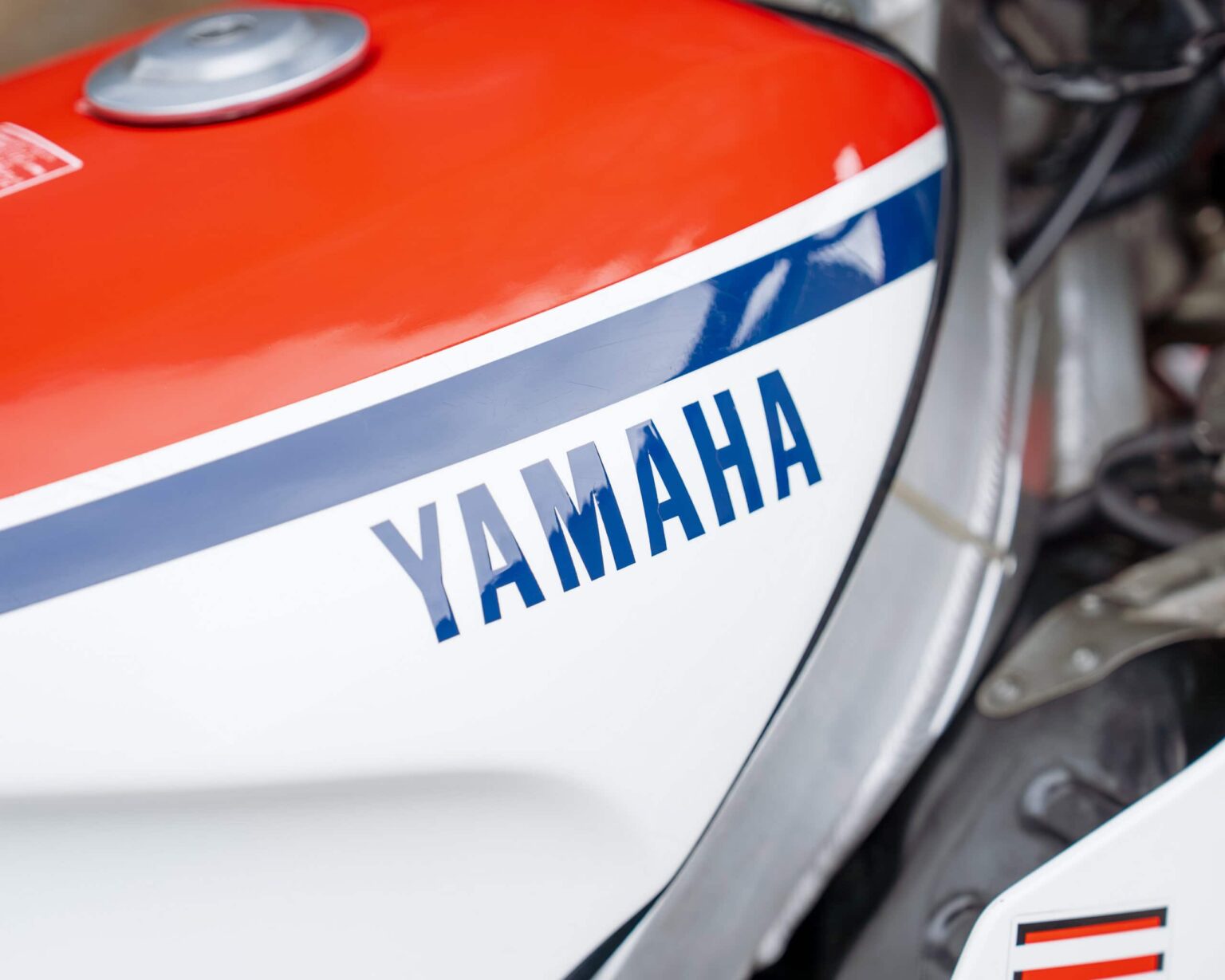 Yamaha logo on a motorcycle fuel tank, close-up shot.