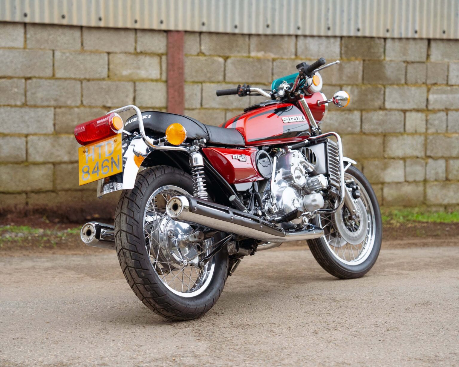 Classic motorcycle with red and chrome finish parked outdoors.
