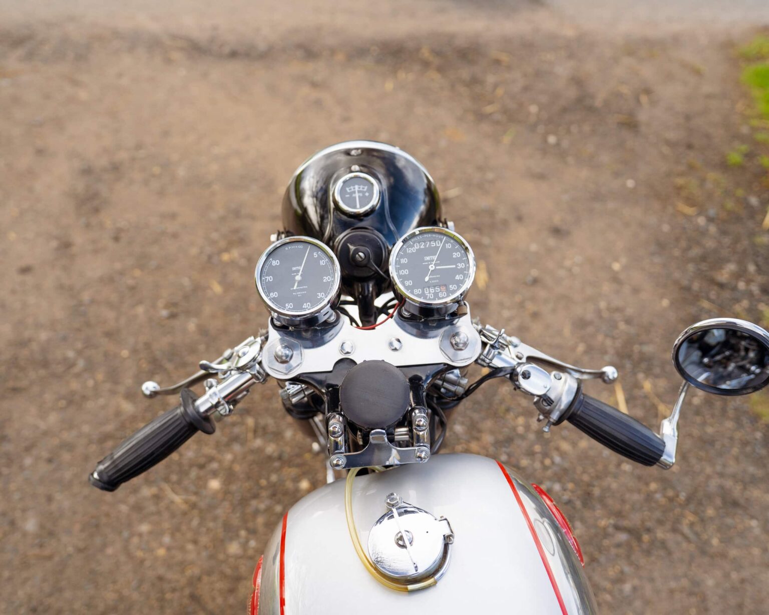 Motorcycle dashboard with speedometer and tachometer, viewed from above.