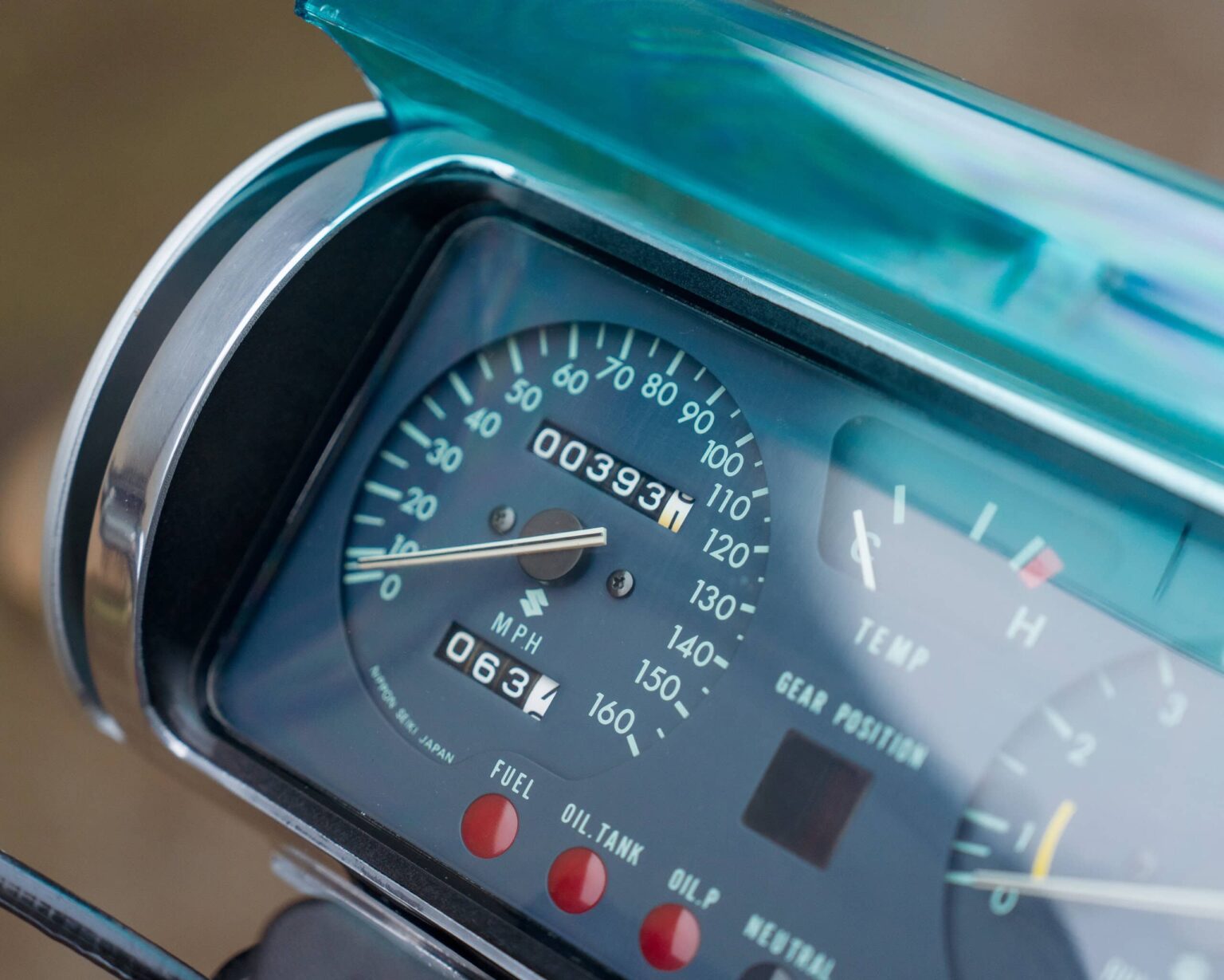 Resolution image of a vintage motorcycle speedometer and gauges.