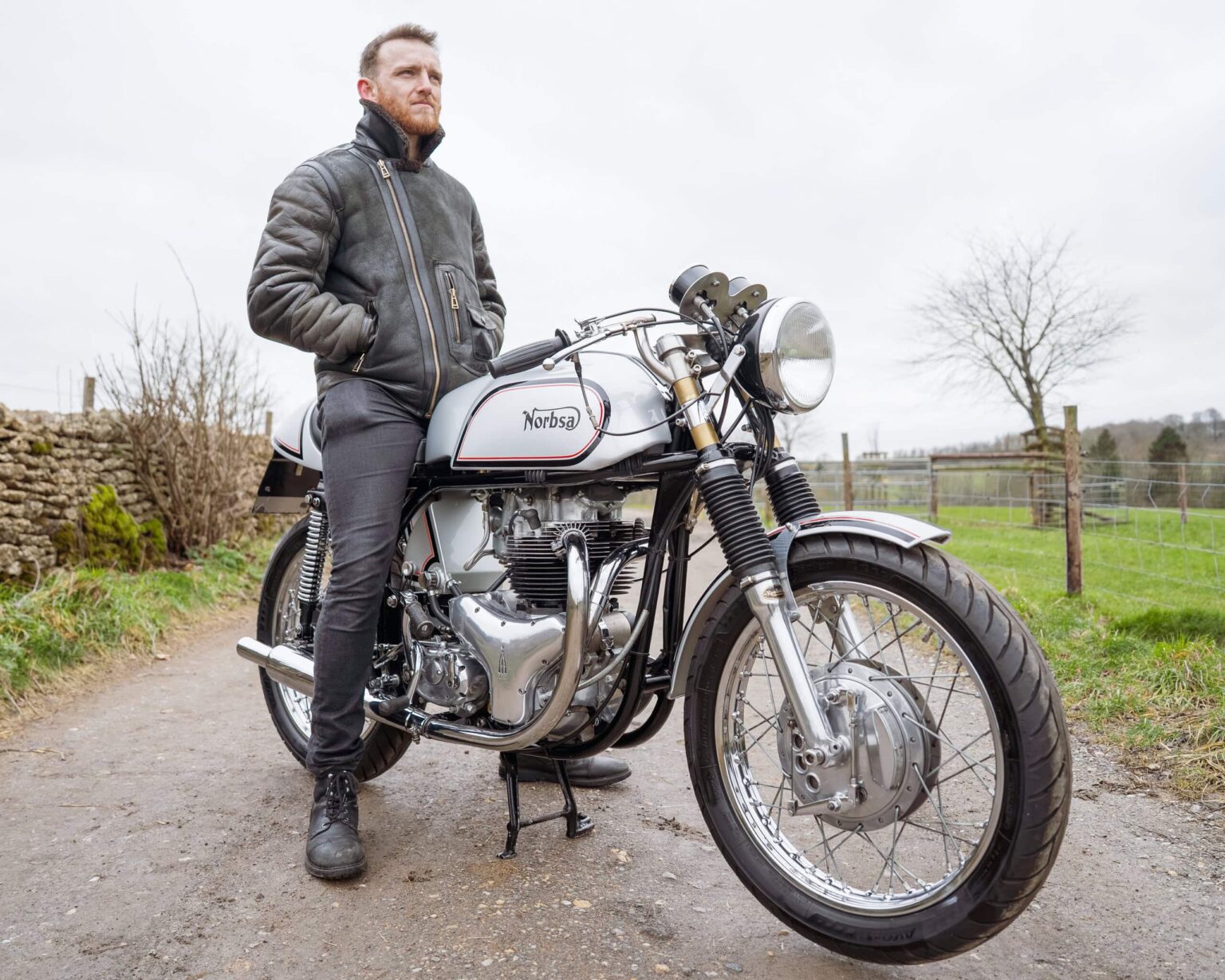 Vintage motorcycle with rider outdoors.