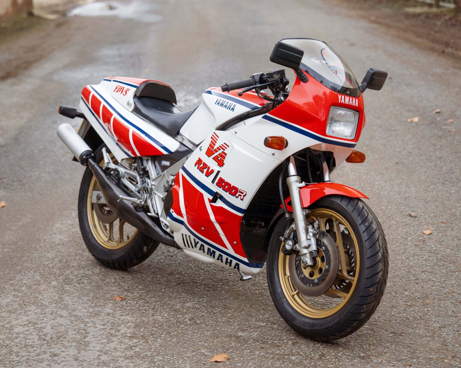 Yamaha RD500R motorcycle with racing livery on a rural road.