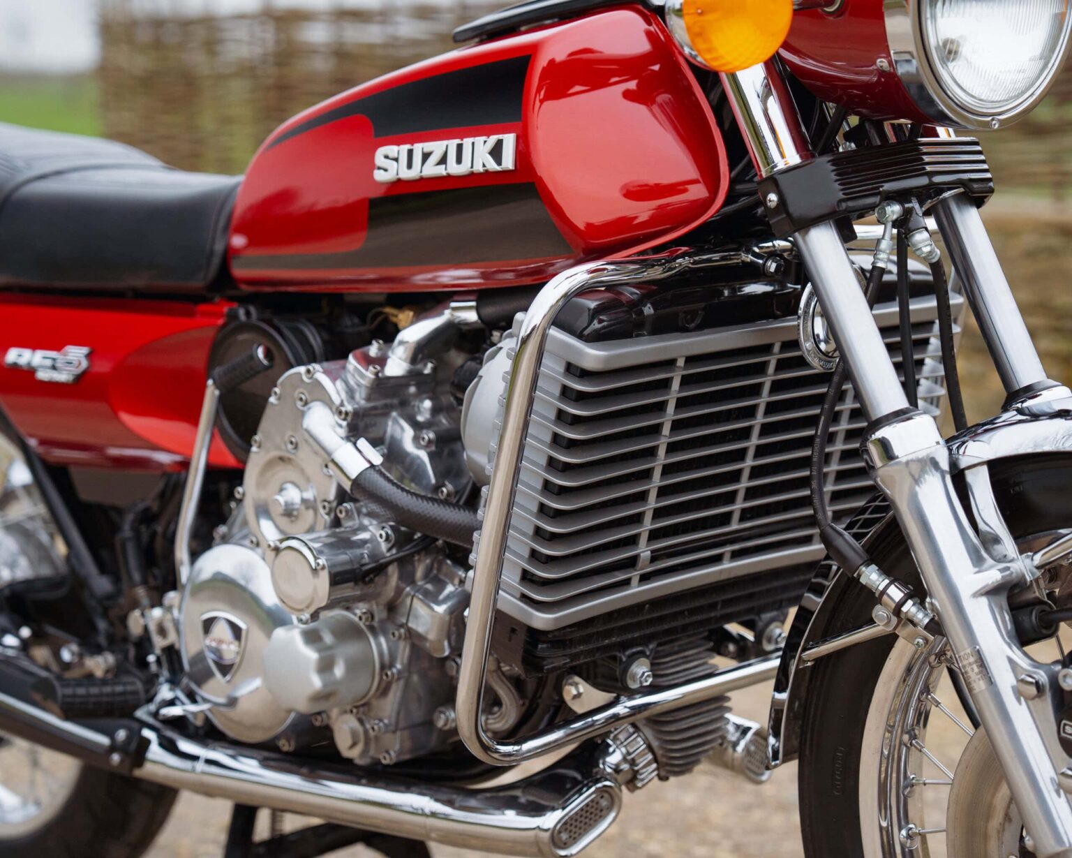 Classic Suzuki motorcycle at a vintage racing event.