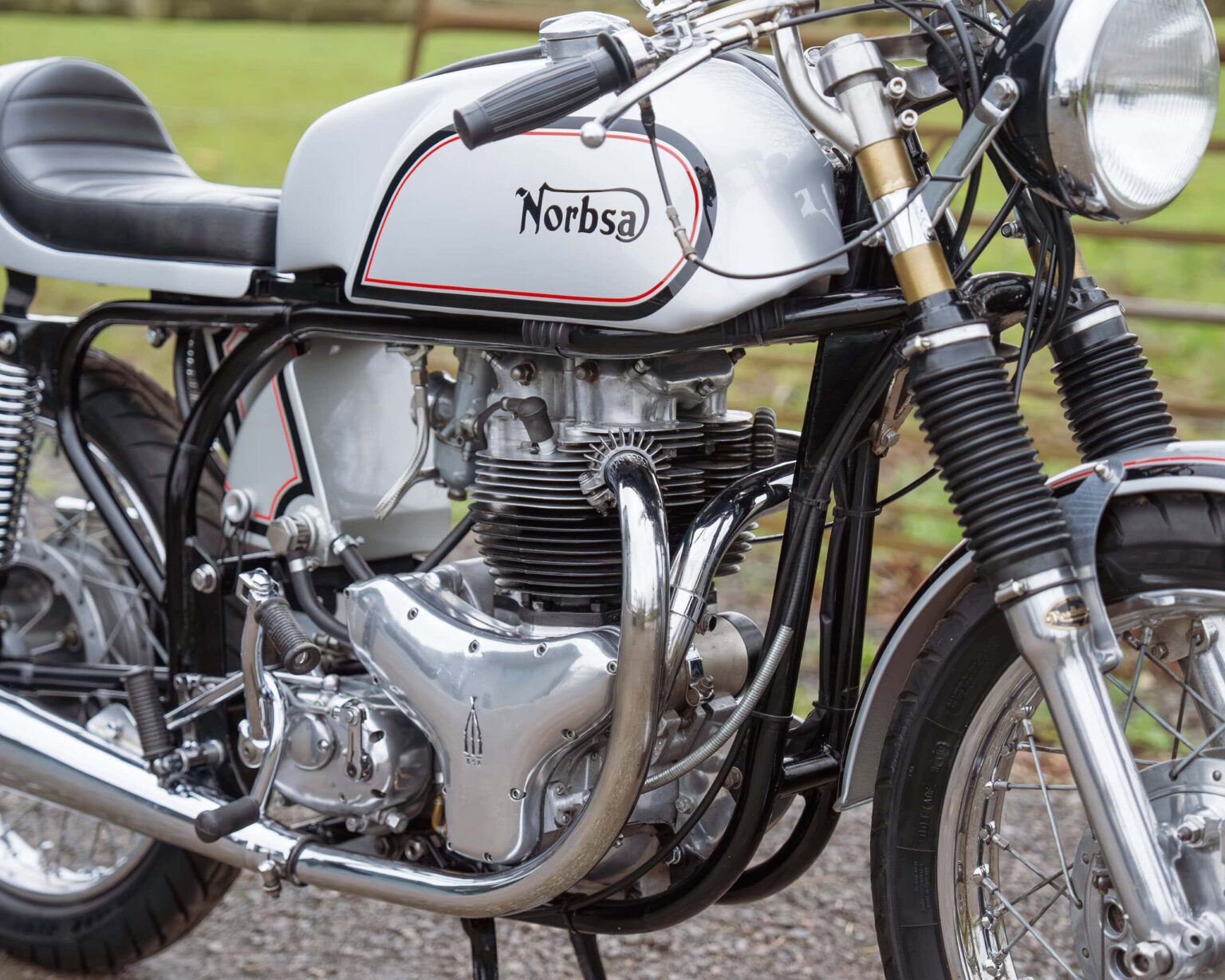 Vintage Norbsa motorcycle with detailed engine and black frame.