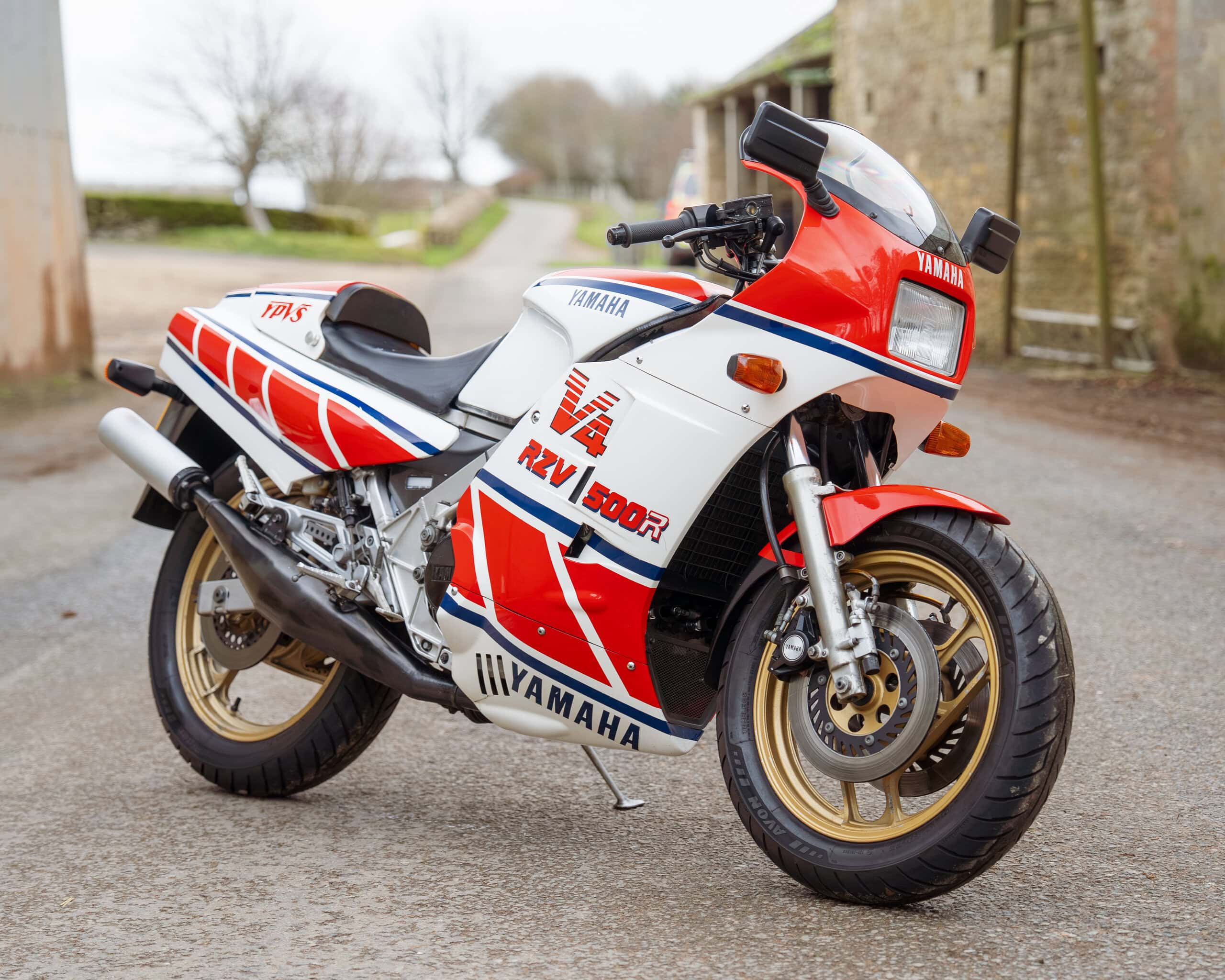 Vintage Yamaha RD500R motorcycle with red, white, and blue racing livery.