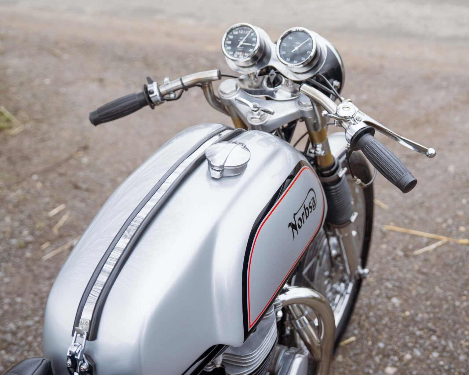 Norton vintage motorcycle with dual gauges and retro style.