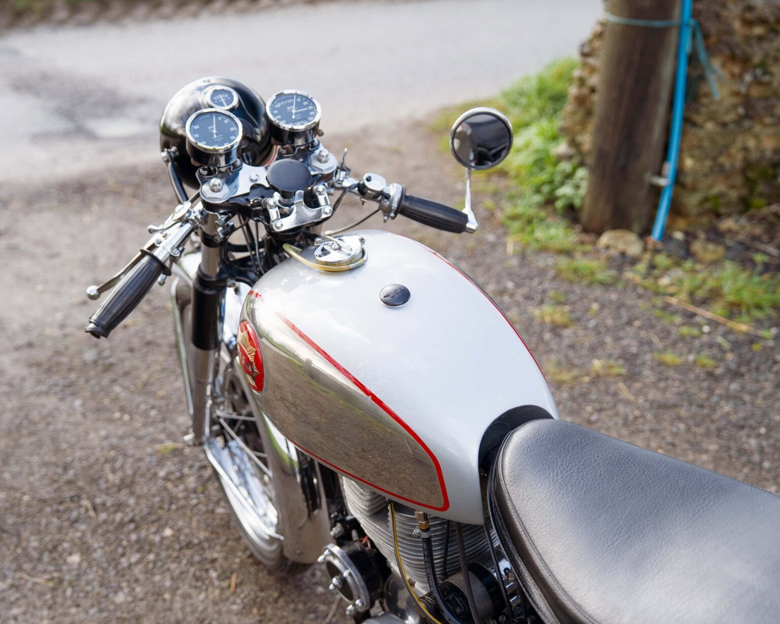 Motorcycle with vintage design and chrome details parked outdoors.
