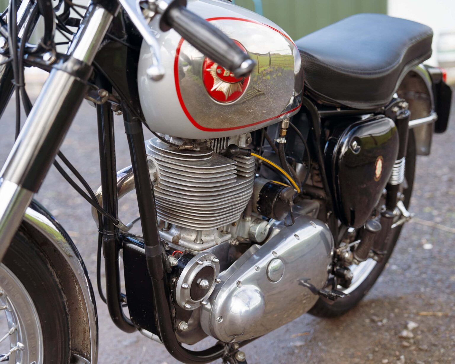 Vintage motorcycle engine with chrome details and black seat.