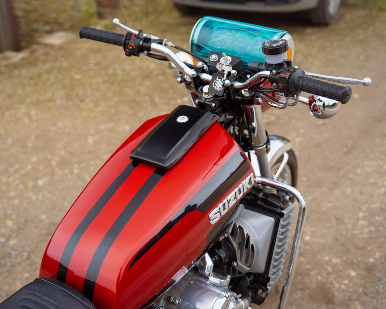 Motorcycle with blue light and racing stripes for classic competition events.